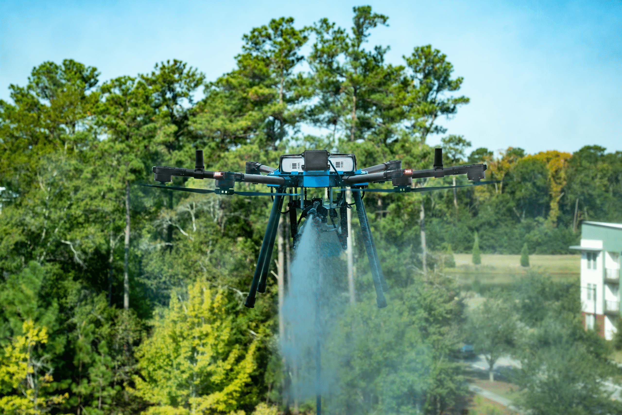Back of Unmanned Aircraft System (UAV) Quadcopter Drone Flying In Front of House